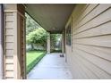 Covered walkway showing a view to the side yard and fence at 4462 Carya Sq, Columbus, IN 47201