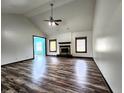 Cozy living room featuring a classic fireplace, wood floors and natural light from the surrounding windows at 4723 Goldenrain Ct, Indianapolis, IN 46237