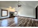 Bright living room with wood floors, vaulted ceilings, fireplace and large windows with natural light at 4723 Goldenrain Ct, Indianapolis, IN 46237