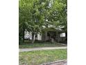 Inviting two-story home with a covered porch and a well-maintained front yard, framed by mature trees at 48 N Audubon Rd, Indianapolis, IN 46219