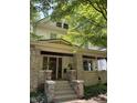 Charming home with a welcoming front porch featuring brick accents and space for hanging plants at 48 N Audubon Rd, Indianapolis, IN 46219