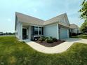Well-maintained home with landscaped yard, welcoming entrance, and an attached two-car garage in a friendly neighborhood at 4817 Allium Dr, Plainfield, IN 46168