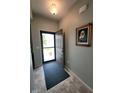 Bright foyer featuring neutral paint, tile flooring, an open door, and decorative wall art at 4817 Allium Dr, Plainfield, IN 46168