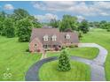 Beautiful aerial view of the home on a large green lot with a winding driveway at 505 Jones Pl, Martinsville, IN 46151
