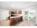Spacious kitchen with granite countertops, modern appliances, bar seating and natural lighting at 5625 Winston Dr, Indianapolis, IN 46226