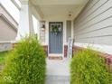 Inviting front porch with a 'Welcome' sign and decorative wreath on the front door at 5684 Autumn Trl, Brownsburg, IN 46112