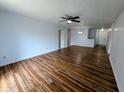 Bright living room boasts wood floors, ceiling fan, and neutral walls, perfect for relaxation at 581 Grassy Bend Dr, Greenwood, IN 46143