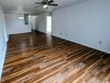 Well-lit living room with beautiful floors, ceiling fan, and an open layout at 581 Grassy Bend Dr, Greenwood, IN 46143