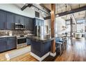 Stunning modern kitchen with dark blue cabinets, stainless steel appliances, and a large island with seating at 630 N College Ave # 409, Indianapolis, IN 46204