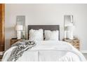 Comfortable main bedroom featuring a bed with white linens, accent pillows, and stylish nightstands at 630 N College Ave # 409, Indianapolis, IN 46204