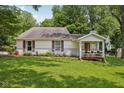 Inviting single-story home with a covered front porch, landscaped garden, and lush green lawn at 6691 N Baltimore Rd, Monrovia, IN 46157