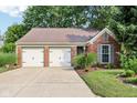 Charming single-story brick home featuring a two-car garage and well-maintained landscaping at 6760 Navigate Way, Indianapolis, IN 46250