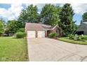 Charming single-story brick home featuring a two-car garage and well-maintained landscaping at 6760 Navigate Way, Indianapolis, IN 46250