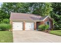 Charming single-story brick home featuring a two-car garage and well-maintained landscaping at 6760 Navigate Way, Indianapolis, IN 46250