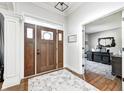 Foyer features a dark wood door with sidelights and transom window, leading to an office space at 6940 Mockernut Ct, Plainfield, IN 46168