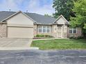 Attractive brick home showcasing a manicured lawn, garage, and inviting front entrance at 6956 Park Square Dr # D, Avon, IN 46123