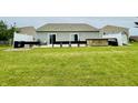 Spacious backyard with a patio, hot tub, black grills, and green space at 7611 Cloudy Ct, Camby, IN 46113
