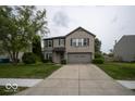 Traditional two-story home with brick front, attached two-car garage, and landscaped front yard at 7657 Wheatgrass Ln, Noblesville, IN 46062