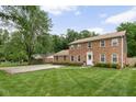 Charming brick two-story home with a manicured lawn and an inviting entrance at 8436 N Meridian St, Indianapolis, IN 46260