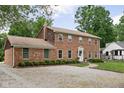 Charming brick two-story home featuring manicured lawn and inviting entrance at 8436 N Meridian St, Indianapolis, IN 46260