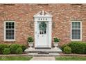 Inviting front entrance with decorative wreath and well-maintained landscaping at 8436 N Meridian St, Indianapolis, IN 46260