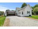 Exterior showcasing the gravel driveway leading to a covered carport at 89 S Grant St, Martinsville, IN 46151