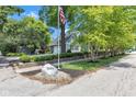 Well-manicured lawn featuring mature trees, garden beds, and home with a detached garage at 900 W Busby St, Lebanon, IN 46052