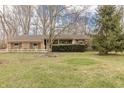 Lovely single-story brick home featuring a well-kept lawn, mature trees, and inviting curb appeal at 10130 Central Ave, Carmel, IN 46280