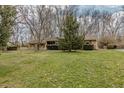 Attractive single-story brick home with a well-maintained lawn and mature trees in a serene environment at 10130 Central Ave, Carmel, IN 46280