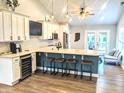 Modern kitchen featuring white cabinetry, a central island with bar stools, and stainless steel appliances at 10421 Sand Creek Blvd, Fishers, IN 46037