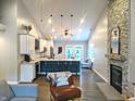 An open layout connects the kitchen with the living area with vaulted ceilings at 10421 Sand Creek Blvd, Fishers, IN 46037