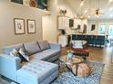 Open-concept living room with modern furnishings, hardwood floors, and ample natural light at 10421 Sand Creek Blvd, Fishers, IN 46037