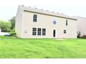 A large backyard with a view of the back of a two-story home at 10501 Morning Song Dr, Fishers, IN 46038