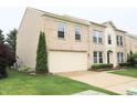 Two-story brick home featuring a two-car garage and well maintained lawn at 10501 Morning Song Dr, Fishers, IN 46038