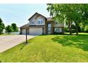 Beautifully landscaped front yard with lush green lawn and mature shade trees at 10519 Hyacinth Ct, Noblesville, IN 46060