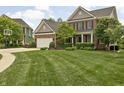Inviting home with a lush front lawn, brick accents, and a neatly paved driveway leading to a garage at 1237 Wolcott Ct, Westfield, IN 46074