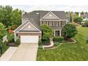 Charming home featuring a brick facade, well-kept lawn, and an attached two-car garage at 1237 Wolcott Ct, Westfield, IN 46074