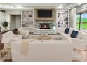 Bright living room with a stone fireplace, built-in shelves, and stylish white sofas at 1412 10Th St, Danville, IN 46122