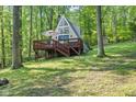 A-frame cabin featuring a spacious deck and beautiful wooded surroundings, perfect for relaxation at 1413 N Lost Lake Rd, Columbus, IN 47201