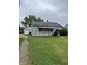 View of the front of the house with a driveway leading to a detached garage at 1609 N Outer Dr, Lebanon, IN 46052