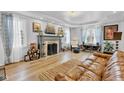 Bright living room boasts hardwood floors, fireplace with mantel, and a cozy seating area at 1618 Villa Ave, Indianapolis, IN 46203
