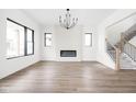 Bright living room features sleek fireplace, hardwood floors, and staircase at 1654 Fernley Dr, Westfield, IN 46074