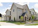 An expansive view of this two-story home, showing a fenced yard and complementing the exterior colors at 1655 Carrollton Rail Dr, Westfield, IN 46074