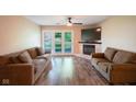 Spacious living room features hard wood floors, a fireplace, and access to a balcony at 207 Keats Ct # 102, Carmel, IN 46032