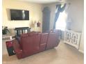 Cozy living room features neutral walls, carpet flooring, and large TV for relaxing evenings at 2253 Jaybird Dr, Greenfield, IN 46140