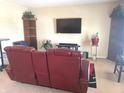 Comfortable living room offers media center with a large TV for entertainment and a view of shelves at 2253 Jaybird Dr, Greenfield, IN 46140