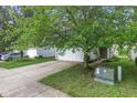 Home featuring neutral siding, two-car garage, driveway and mature trees at 2270 Collins Way, Greenfield, IN 46140
