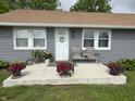 Charming front porch featuring colorful flowers and a cozy seating area at 260 S 250 W, Greenfield, IN 46140
