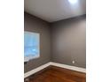 Bedroom featuring bare walls, hardwood floors and a window at 319 S Temple Ave, Indianapolis, IN 46201