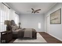 Comfortable bedroom with a wood-look ceiling fan, neutral tones, and a decorative rug at 3226 Keystone Lakes Way, Indianapolis, IN 46237